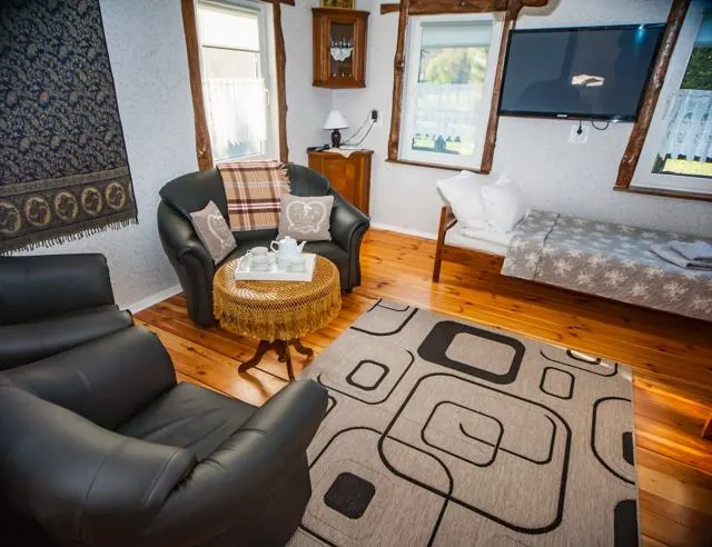 Room with tiled stove and sitting area – Gaja holiday home, Białowieża Forest